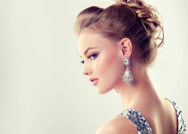Young gorgeous girl dressed in evening gown and delicate makeup on. stock photo