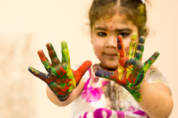 istock Little girl showing colorful painted hands 652266204