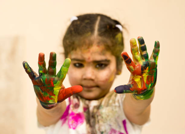 istock Little girl showing colorful painted hands 652266490