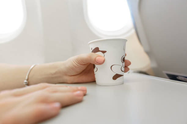 istock Woman  drinking coffee on airplane. 652270036