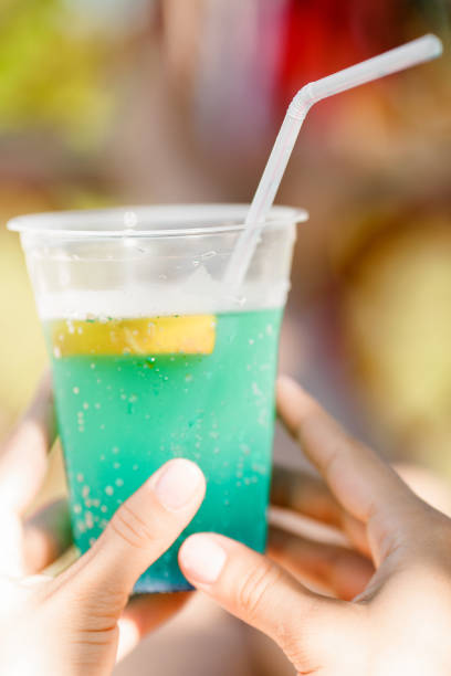 istock woman holding cocktail in the hammock 652273696