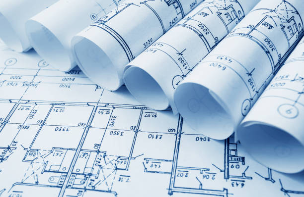 istock Architect workplace. Architectural project, blueprints, blueprint rolls on wooden desk table. Construction background. Engineering tools. Copy space 652277026