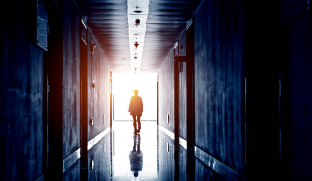 istock woman walking into the light 652277118