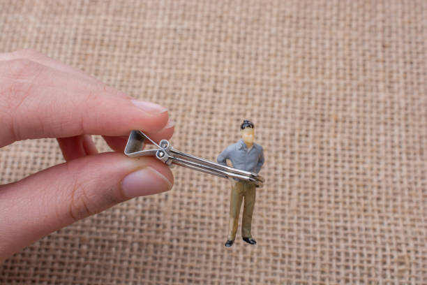 istock Man figurine in hand on linen canvas background 652278702