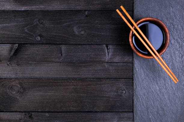 istock Background for sushi. Soy sauce, chopsticks on black stone. Top view with copy space 652290884