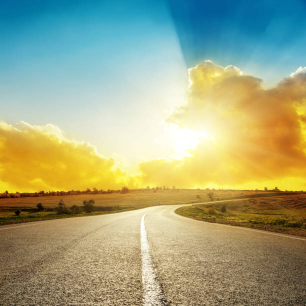 istock bright orange sunset over asphalt road 652300338