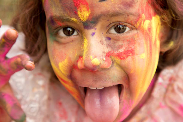 istock Little girl painted her face with multi colors 652302792