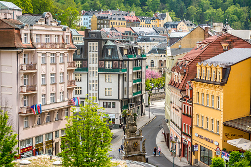 Karlovy Vary, Czech Republic - May 5, 2015: Karlovy Vary cityscape in springtime with luxury shops, cafes  and people sightseeing.