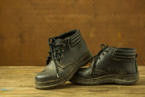 istock Dirty black shoes with old steel background 652302946