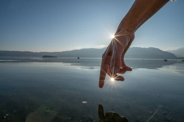 istock Human hand cupped to catch fresh water from lake 652306038