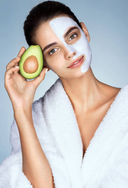 istock Charming young girl holding half an avocado in hand. 652324976
