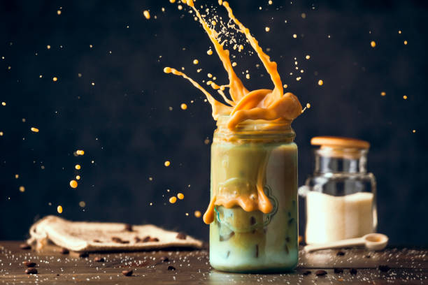 istock Fresh Cold Iced Coffee Splashing Blue Mason Jar On Wood Table. Copy Space With Selective Focus. 652328620
