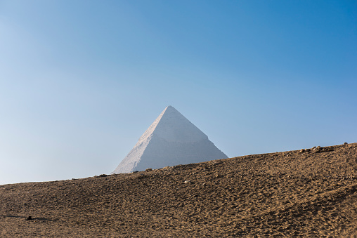 View of the top of Pyramid of Khafre. The Giza Pyramids complex is an archeological site very close to Cairo, Egypt.  The complex have among others,  the three Great Pyramids and the Great Sphinx sculture,  This is one of the Seven Wonders of the World.