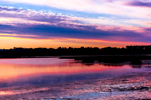 Multi colored clouds and lake reflection at dawn on Lake Wausau in Wausau, Wisconsin.
