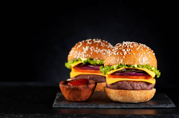 istock Beef burgers cheeseburgers on a black chalkboard 652335280