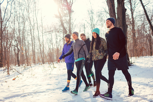 Running team after jogging during cold winter day in park