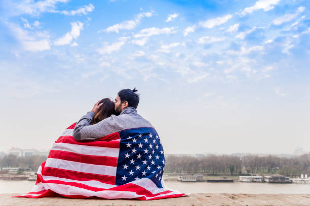istock Funky young couple covering with American flag 652355730