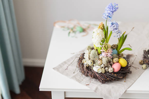 istock Flower arrangement in a nest with easter eggs on a white table 652363130