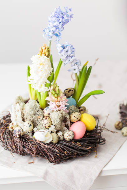 istock Flower arrangement in a nest with easter eggs on a white table 652363610