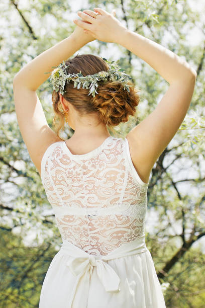 istock Beautiful girl is standing back and keeping her hand up. Wedding. 652372908
