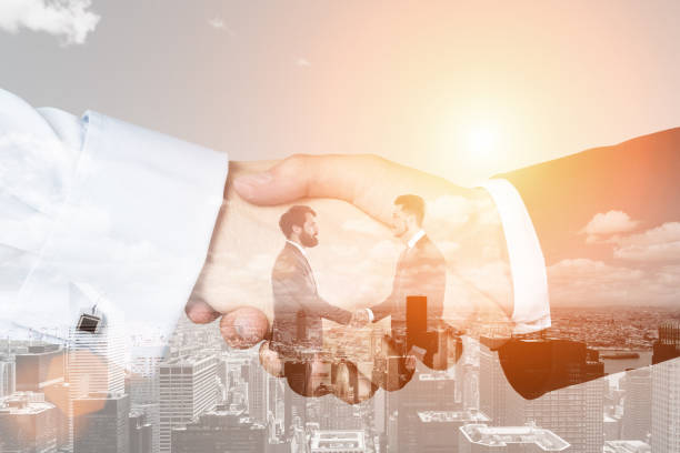 istock Men and handshake close up in a city, toned 652373622