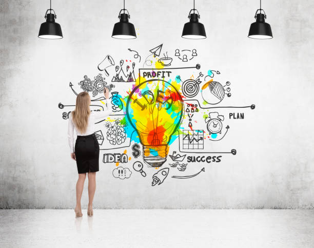 istock Rear view of girl drawing bright light bulb 652376976