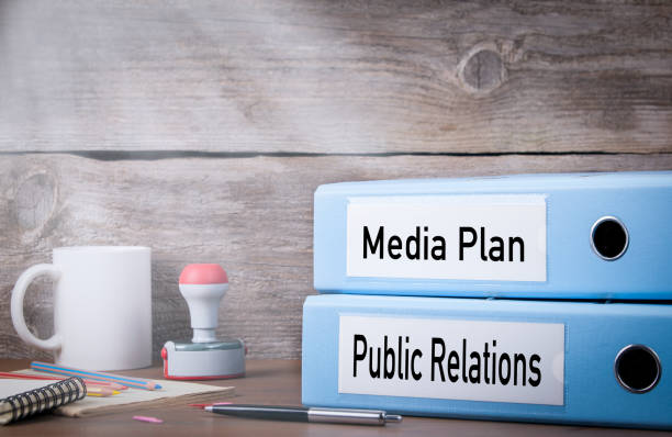 istock Public Relations and Media Plan. Two binders on desk in the office. Business background 652379838