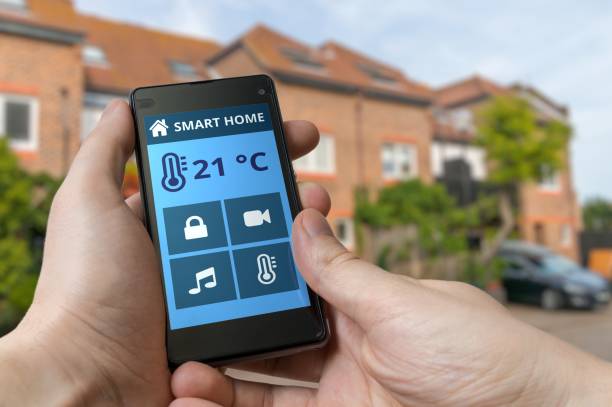 istock Smart home control concept. Man is adjusting temperature with smartphone. 652380822