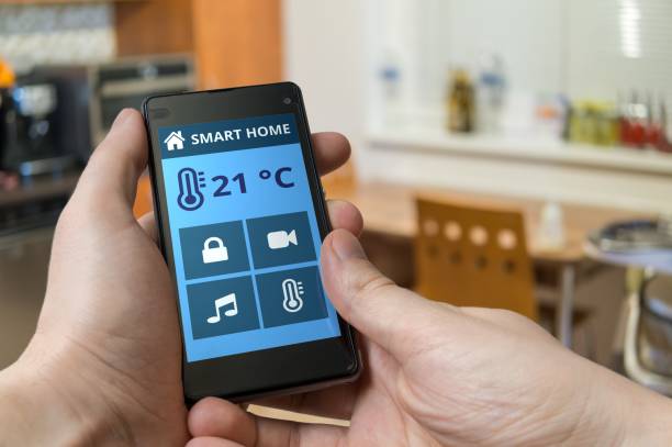 istock Smart home control concept. Man is adjusting temperature with smartphone. 652380920