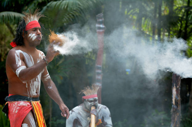 Aboriginal culture show in Queensland Australia Yugambeh Aboriginal warrior demonstrate  fire making craft during Aboriginal culture show in Queensland, Australia. didgeridoo stock pictures, royalty-free photos & images