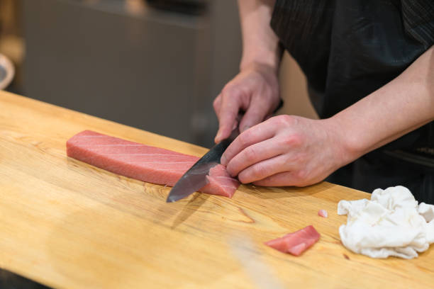 istock Chef preparing a fresh Tuna on a cutting board  for otoro sushi 652391540