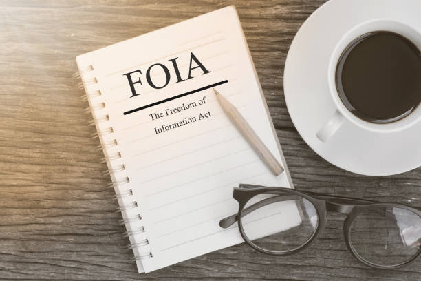 istock Concept  FOIA (The Freedom of Information Act) message on notebook with glasses, pencil and coffee cup on wooden table. 652400990