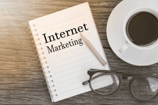 istock Concept Internet  Marketing message on notebook with glasses, pencil and coffee cup on wooden table. 652401042