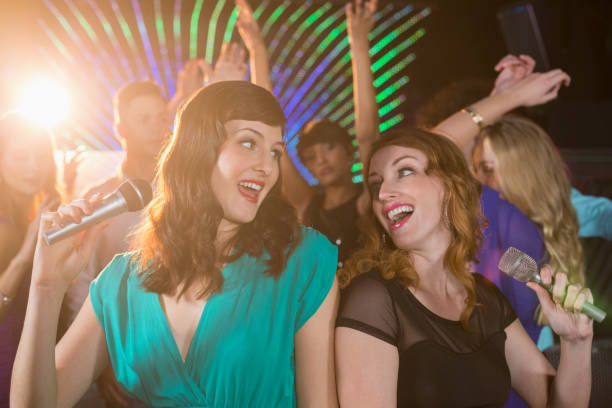 istock Two beautiful women singing song together 652401672