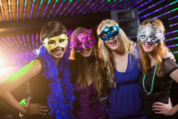istock Female friends wearing masquerade in bar 652401784