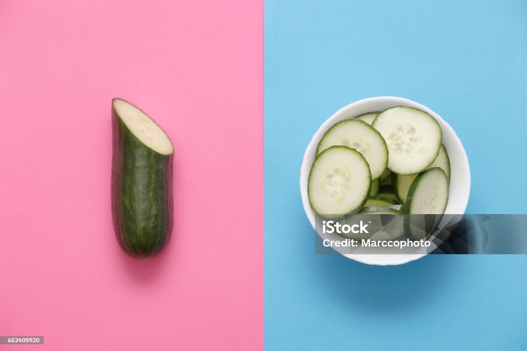White bowl full of sliced and half cucumber on rose quartz serenity blue background. Directly above view. photo is taken with dslr camera Cucumber Stock Photo
