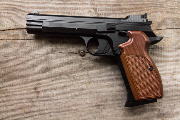 istock Pistol on a wood background. Handle right. 652406380