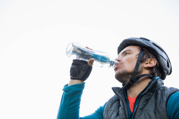 istock Male mountain biker drinking water 652414348