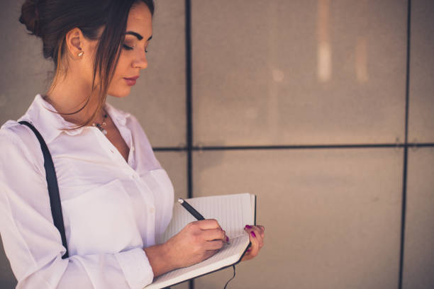 istock Businesswoman writing her busy schedule in the note book 652417458