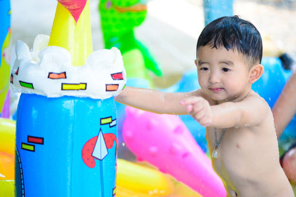 istock Asian kid playing in inflatable baby pool. 652422532