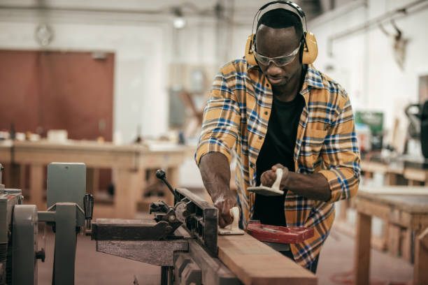 istock Male carpenter working with power tools in his wood shop 652423132