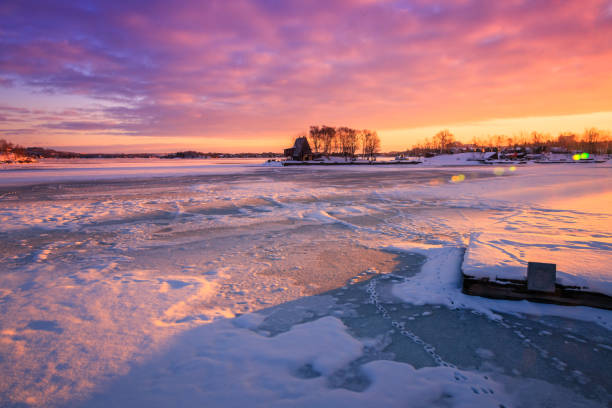 View of a frozen lake during sunrise in winter season. Location: Ramsey Lake, Ontario, Canada