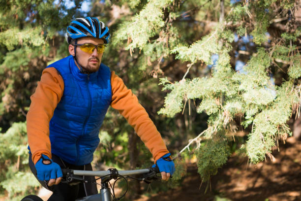 istock Male mountain biker riding bicycle in the forest 652429276