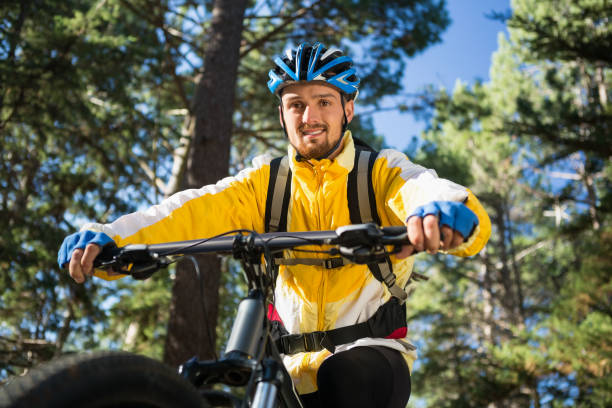 istock Male mountain biker riding bicycle in the forest 652429312