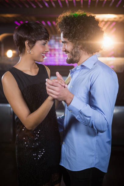 istock Cute couple dancing together on dance floor 652437390