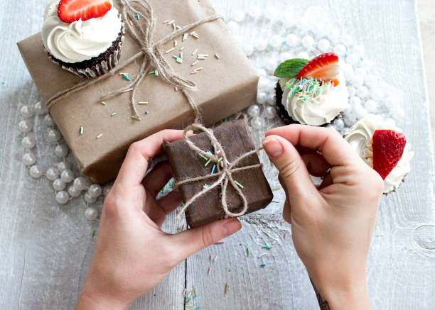 istock Gift boxes and Chocolate cupcake with white creme and strawberry on top 652452776