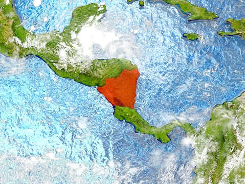 Nicaragua in red on map with detailed landmass texture, realistic watery oceans and clouds above the surface. 3D illustration. 3D model of planet created and rendered in Cheetah3D software, 7 Mar 2017. Some layers of planet surface use textures furnished by NASA, Blue Marble collection: http://visibleearth.nasa.gov/view_cat.php?categoryID=1484