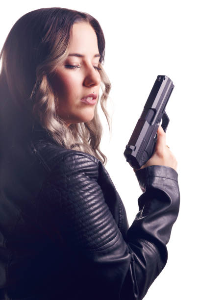 istock Woman wearing leather jacket, holding a pistol. 652466966