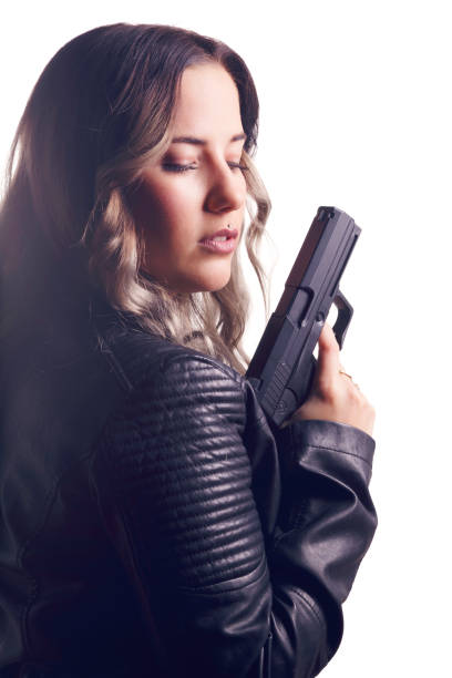 istock Woman wearing leather jacket, holding a pistol. 652467050