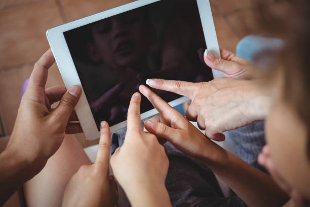 istock Family pointing their fingers at digital tablet 652481998